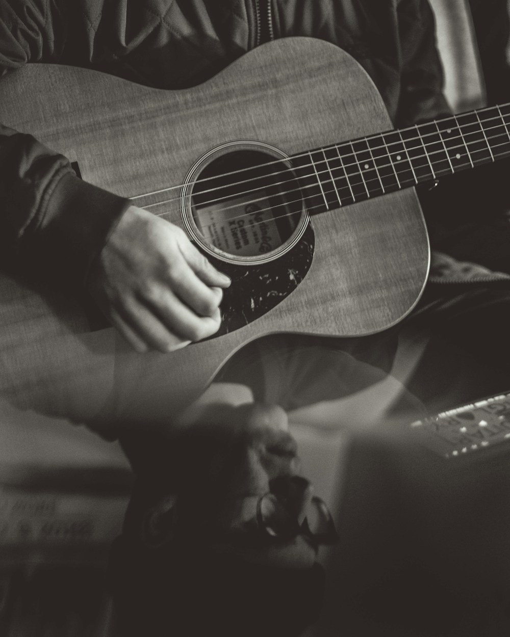A close-up of an acoustic guitar being played